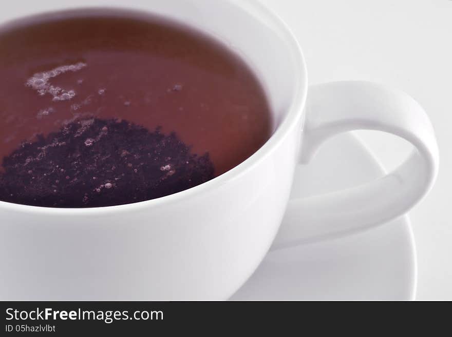 White cup with black tea macro