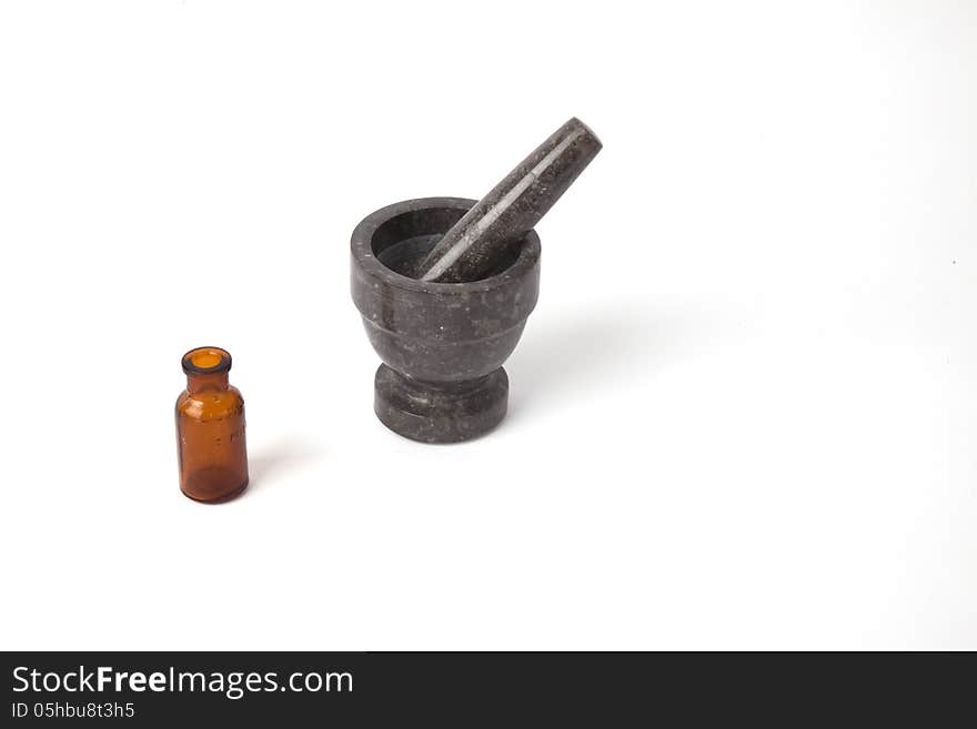 A mortar and pestle with an old medicine bottle.