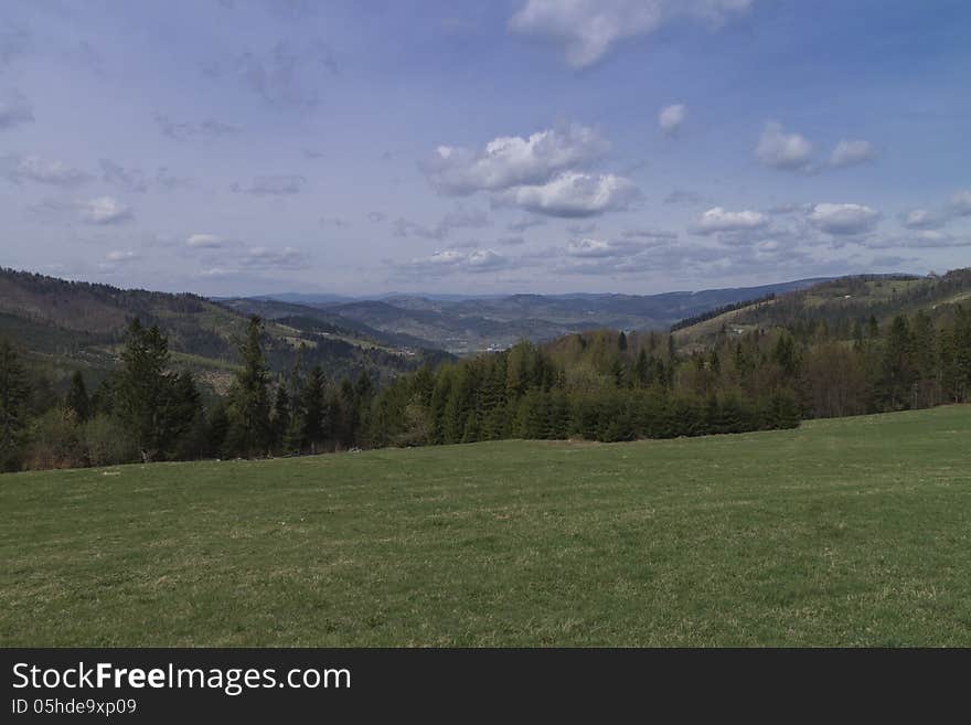 Mountain meadow and cloudy sky