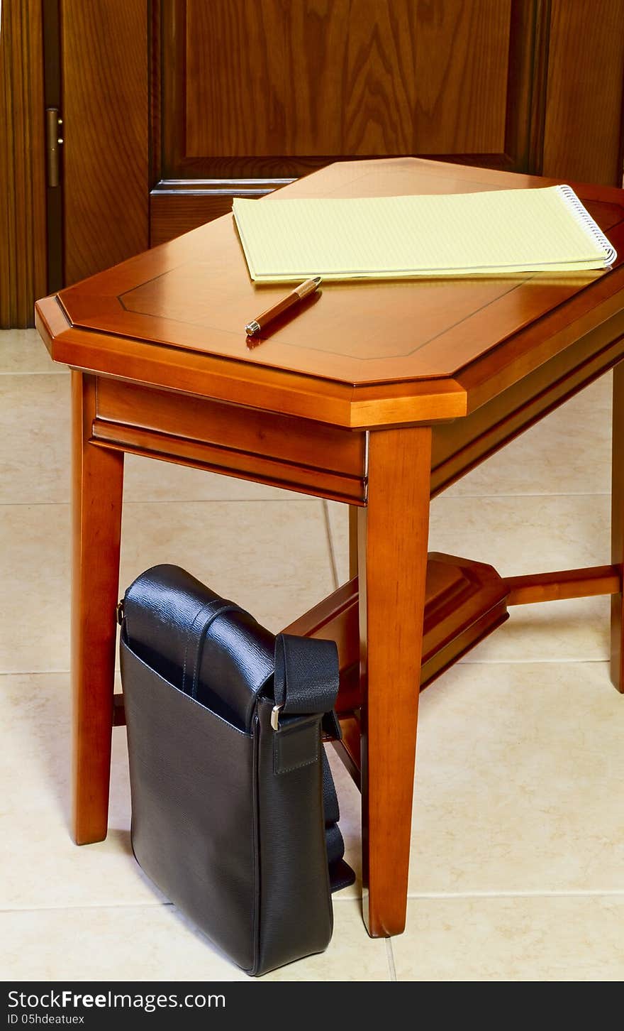 Men's bag next to the coffee table against the door. Men's bag next to the coffee table against the door