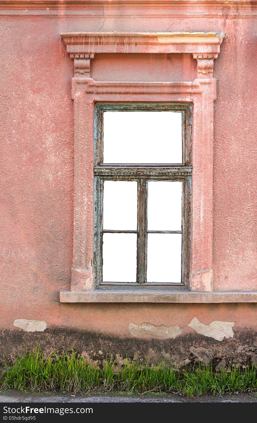 Old window frame on the wall with grass