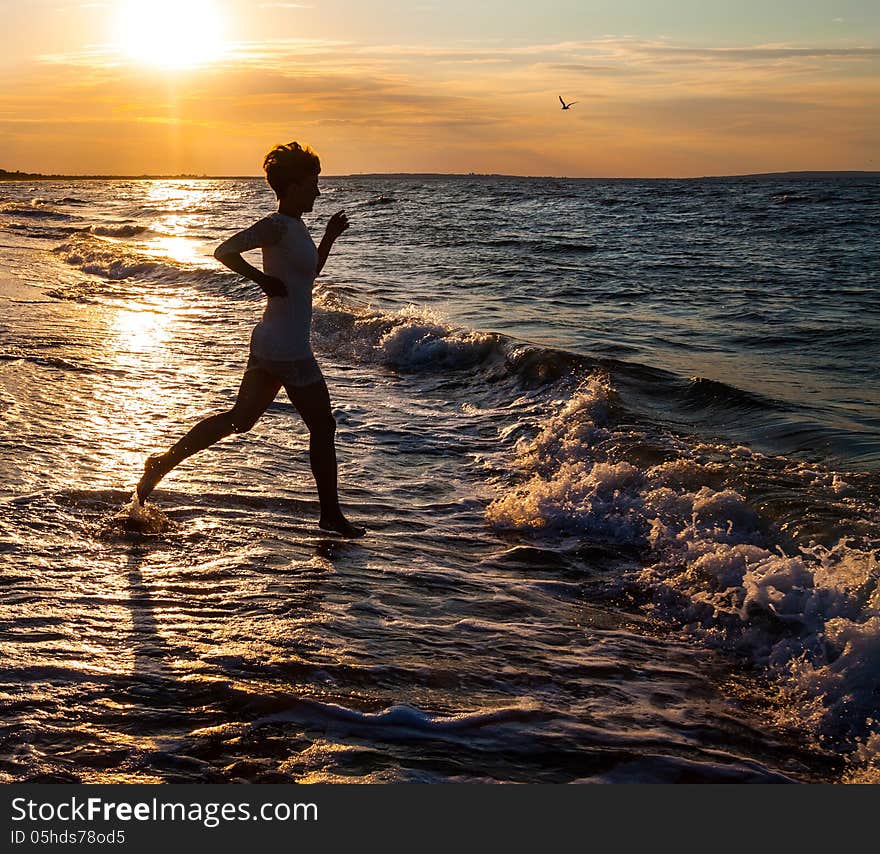 Silhouette of beautiful girl running on beach. Silhouette of beautiful girl running on beach