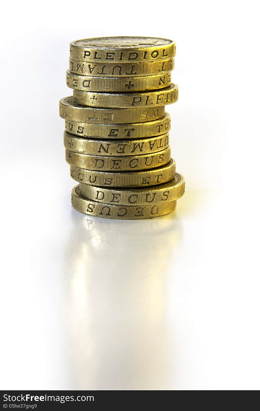 Stack of British One Pound coins with subtle reflection. Stack of British One Pound coins with subtle reflection