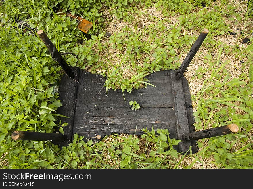 Charred wooden table turned upside down. Charred wooden table turned upside down