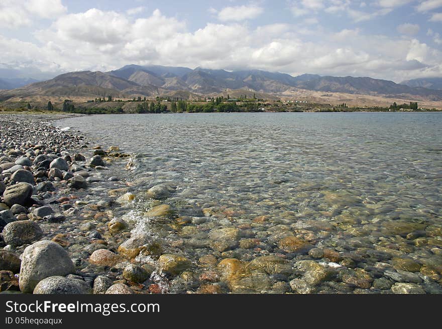 Stone coast of lake. Kyrgyzstan.