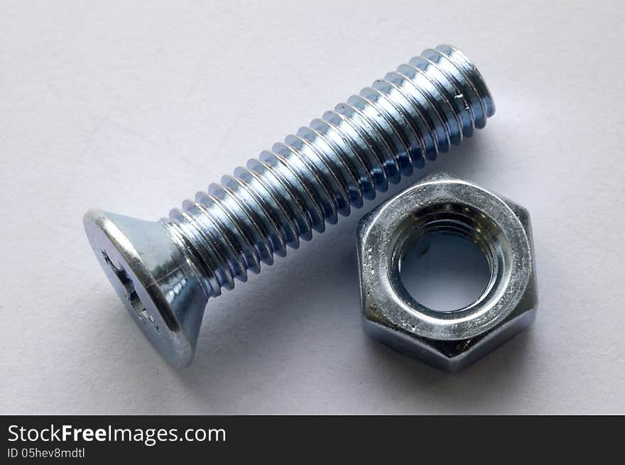 The large bolts and screws on a white background. The large bolts and screws on a white background.