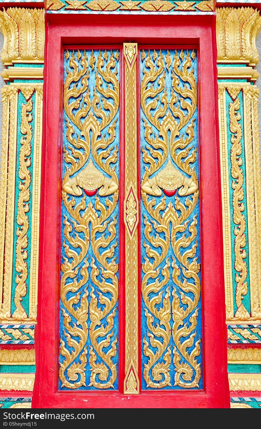 Golden and red Thai temple door sculpture