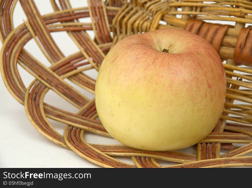 Red apple on a background of a wum vase. Red apple on a background of a wum vase.