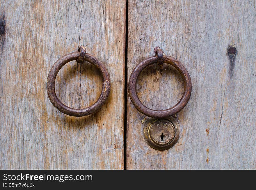 Old doorknob on wood background