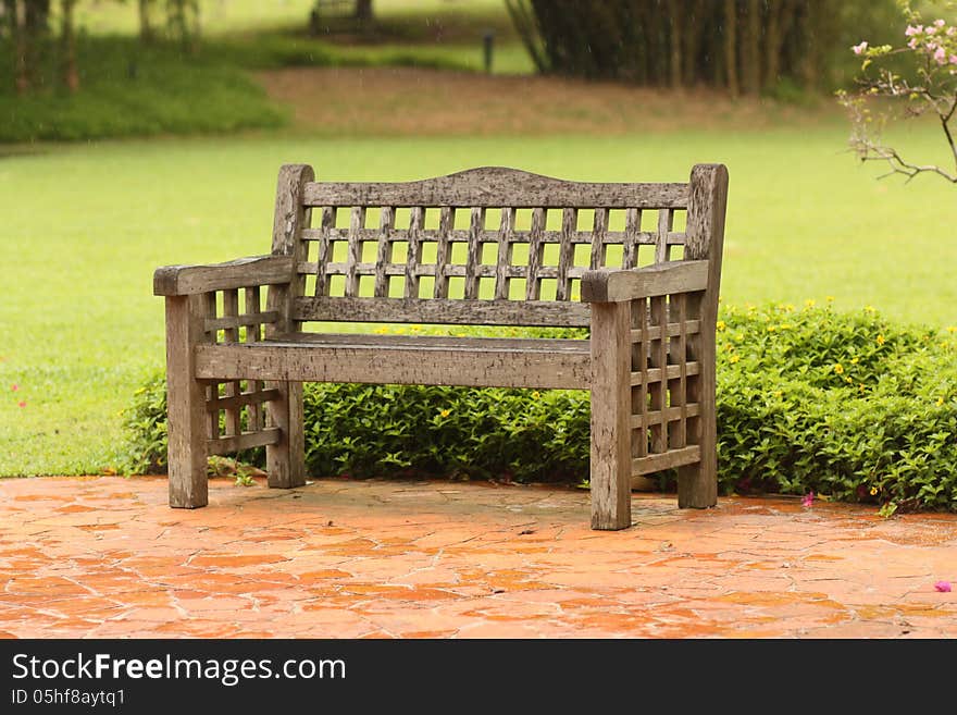 A chair in rain at botanic garden