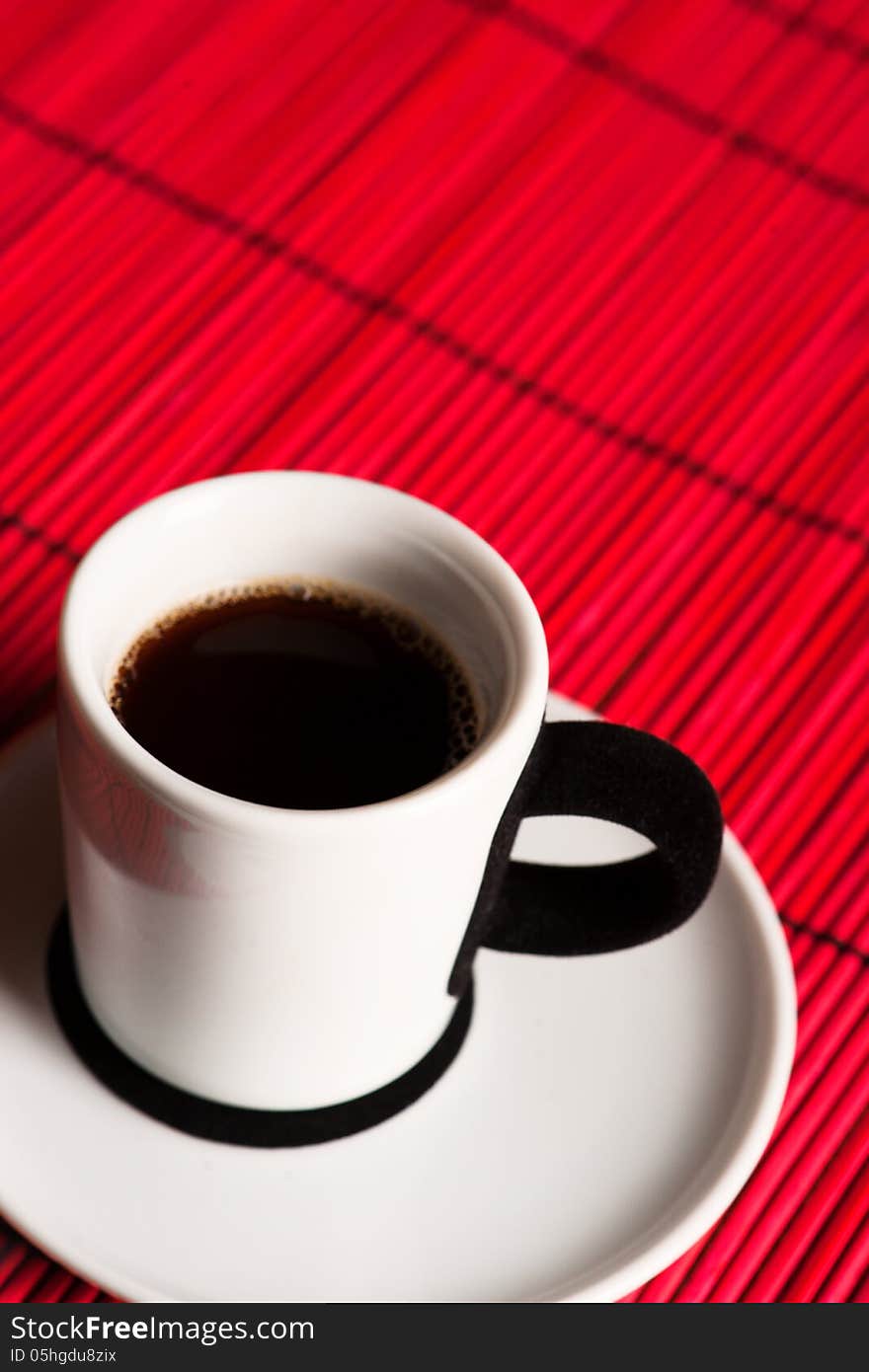 Fresh brewed coffee over red background. close up