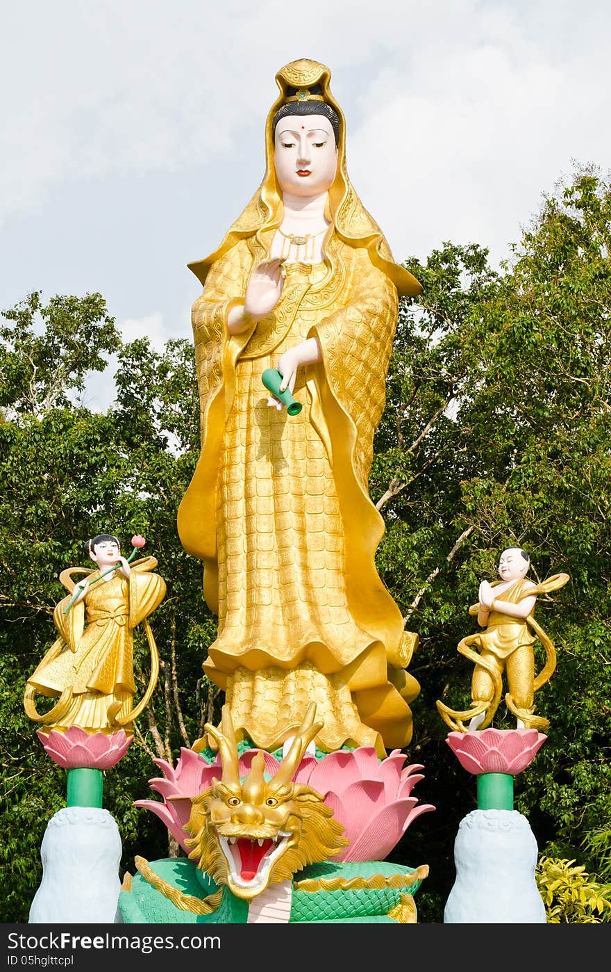 Golden statue of Guan Yin with children in temple at Phan Nga, T