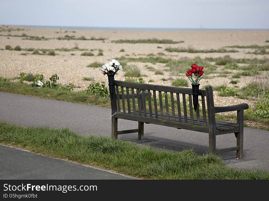 Empty bench with flowers on Kent coast