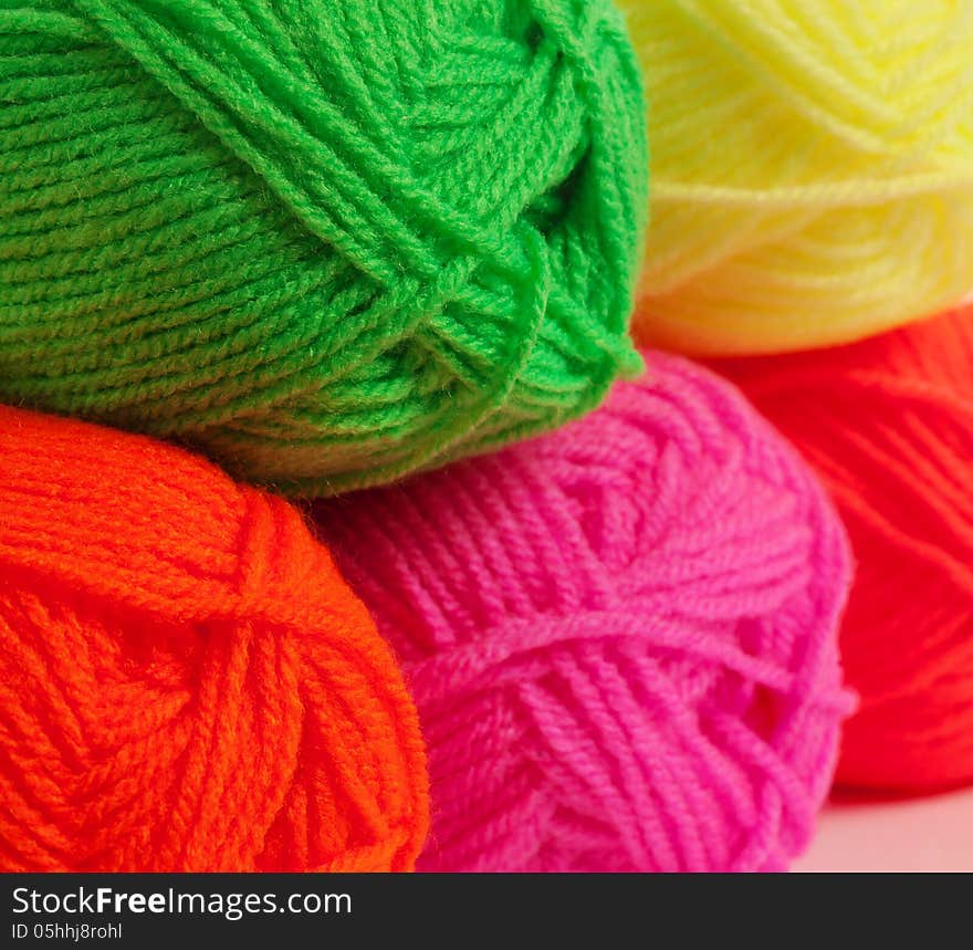 Multicolored wool rolled into balls in the shop, closeup. Multicolored wool rolled into balls in the shop, closeup