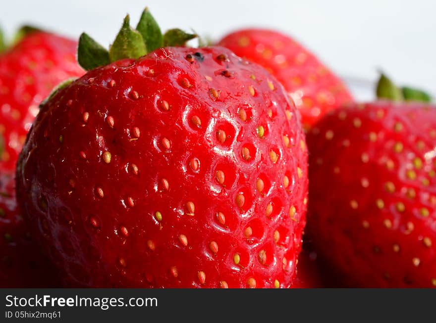 Macro shot of strawberries isolated on white, shallow depth of field