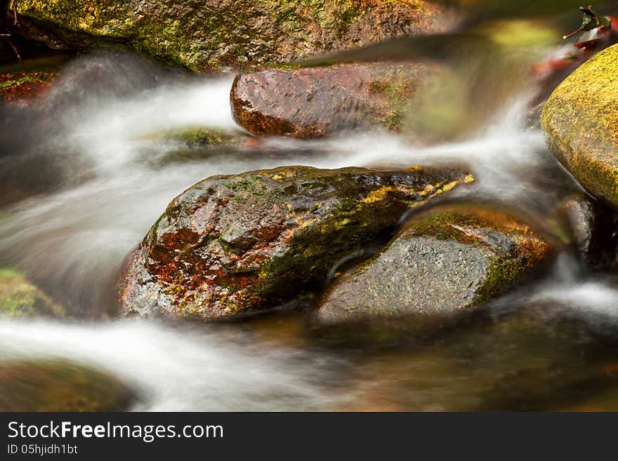 Beautiful veil cascading waterfall, mossy rocks