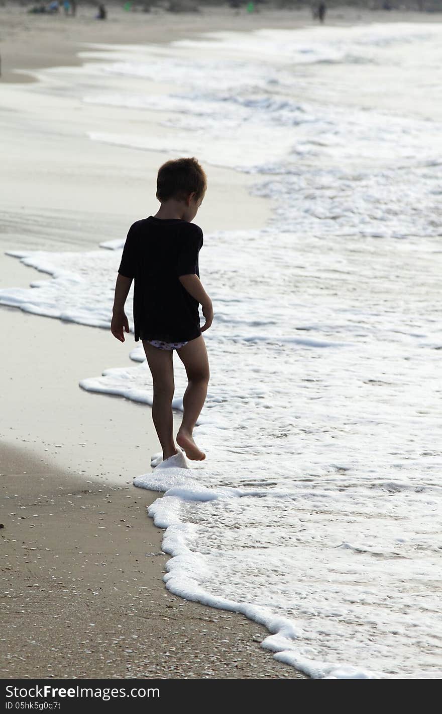 Child at the sea on sunset colors