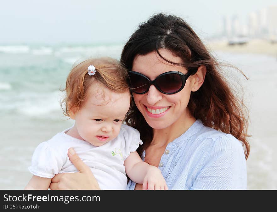 Mother and little daughter on the beach