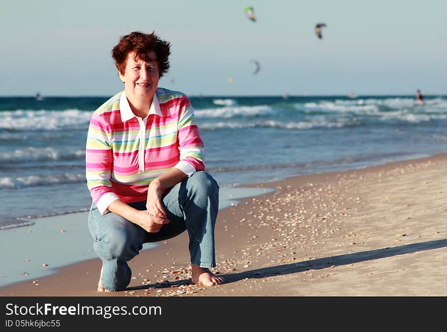 Happy senior woman on summer vacation at sea