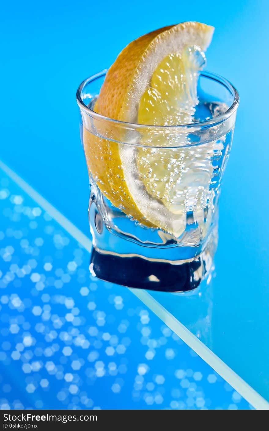 Gin With Lemon On A Glass Table