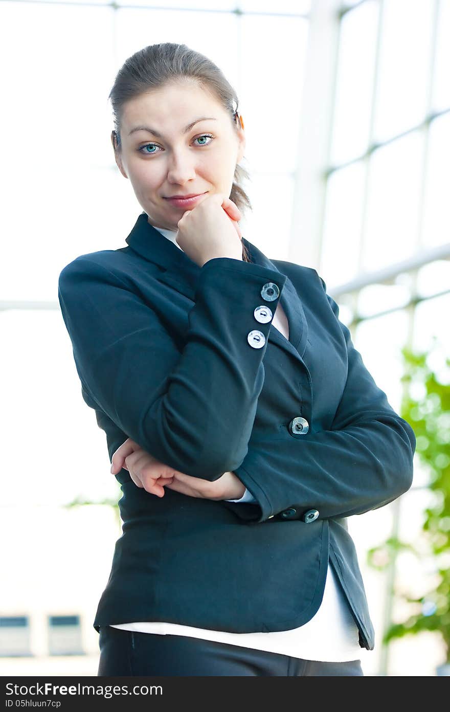 Portrait of successful business woman smiling on the background of a blurred office interior