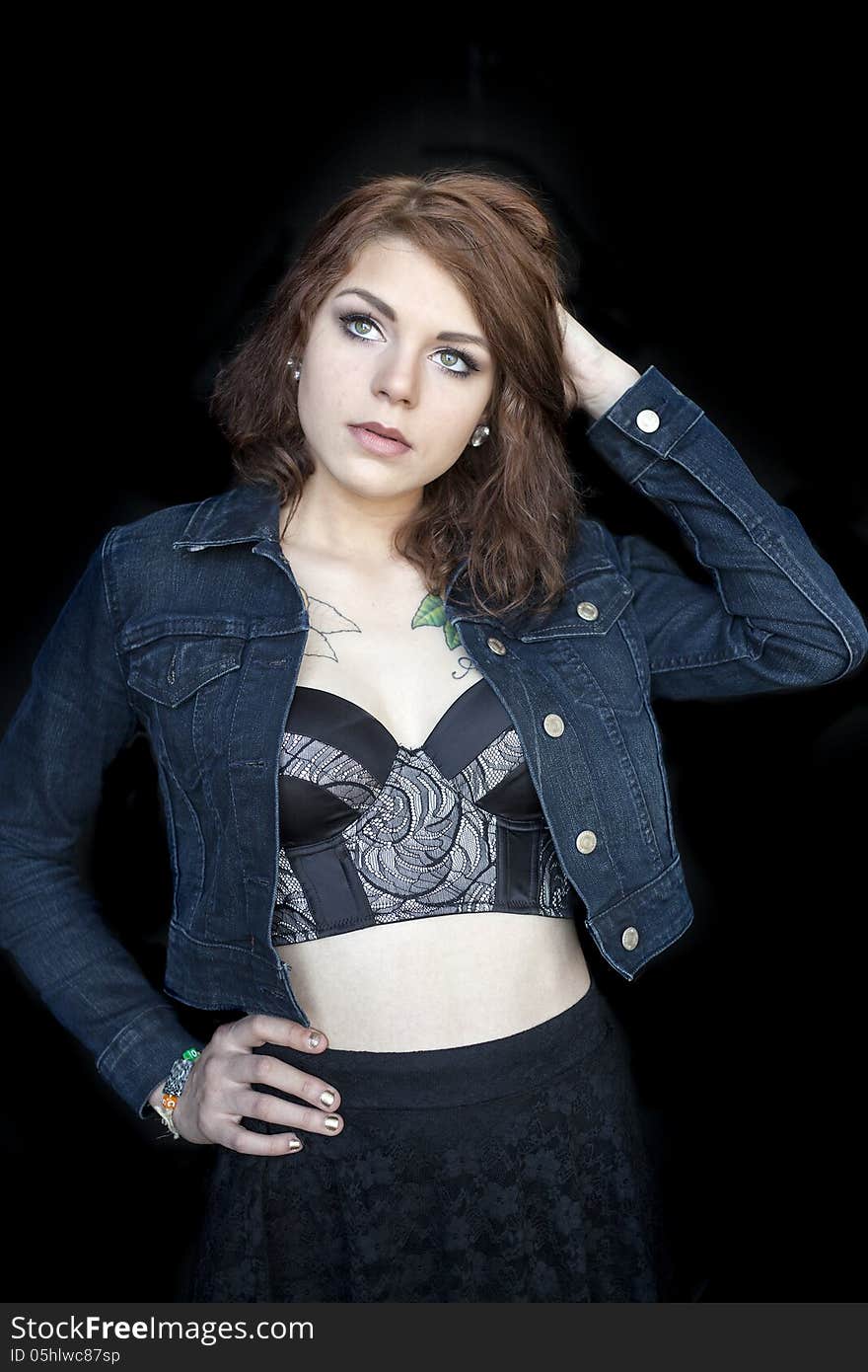 Portrait of a beautiful young woman in a black bustier. Portrait of a beautiful young woman in a black bustier.