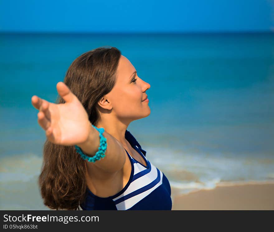 The young woman standing on a beach