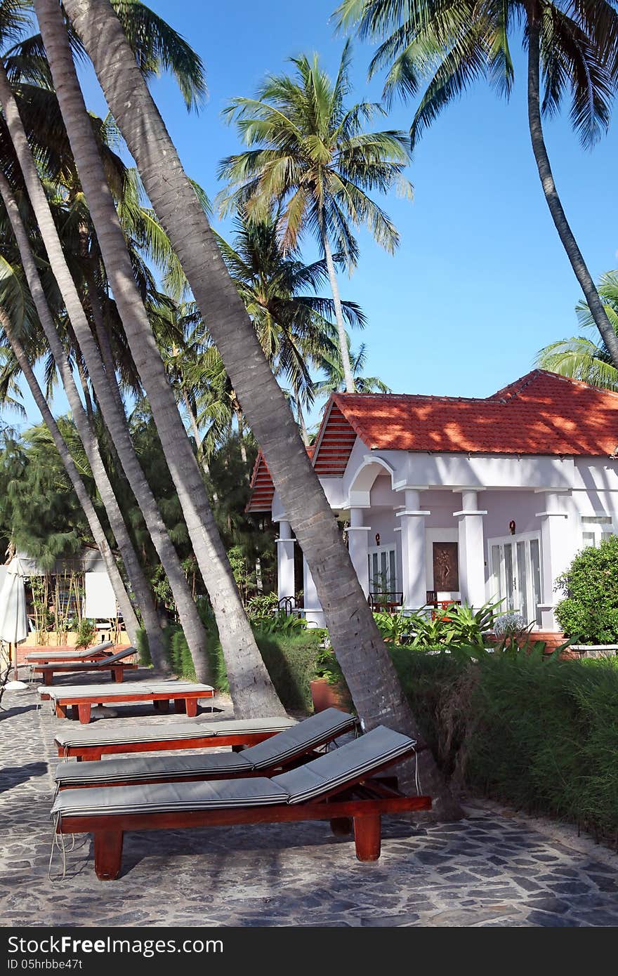 Chair lounges and luxury houses in tropical resort on the beach. Chair lounges and luxury houses in tropical resort on the beach