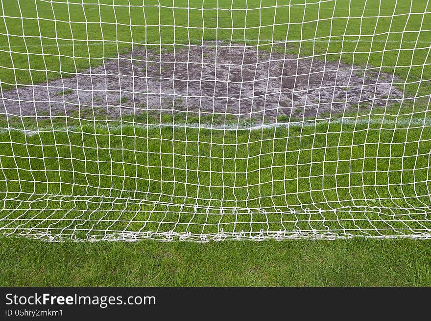 Goalmouth on football field. view through the mesh gate. Goalmouth on football field. view through the mesh gate