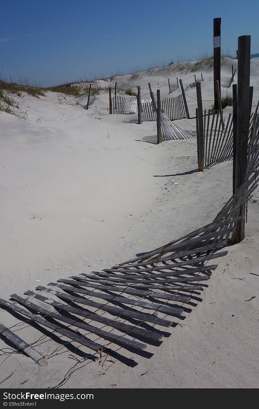 Fences on white sandy beach