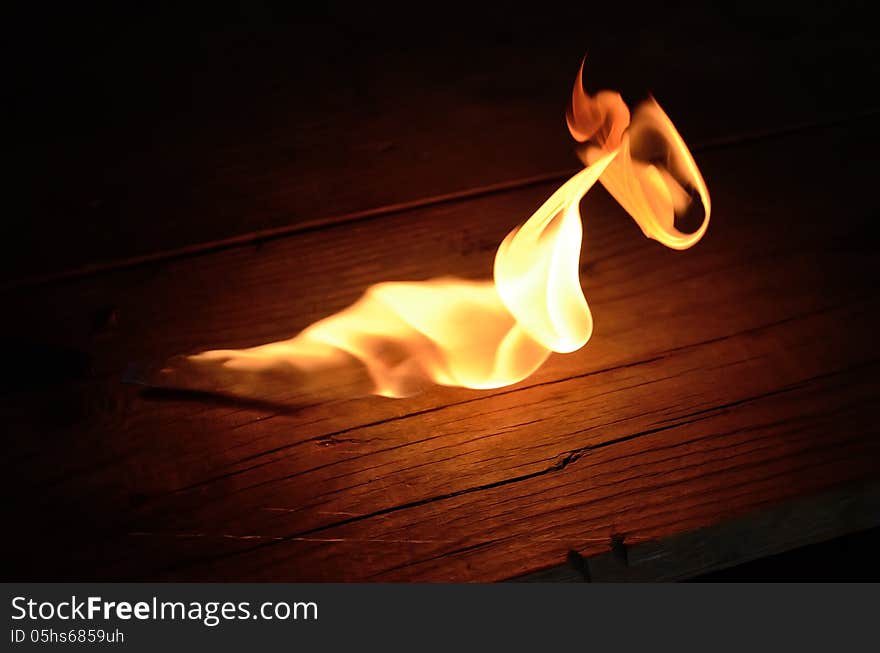 Flame of gas burner on the wooden floor. Flame of gas burner on the wooden floor.