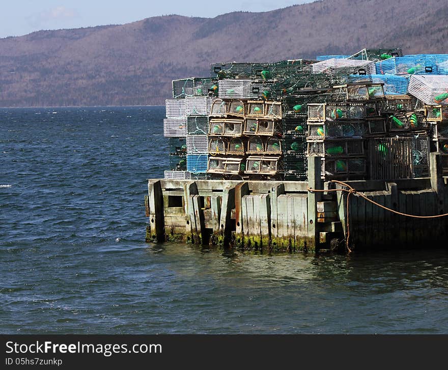 Lobster traps sit stacked on a wharf in Nova Scotia, Canada. Lobster traps sit stacked on a wharf in Nova Scotia, Canada.