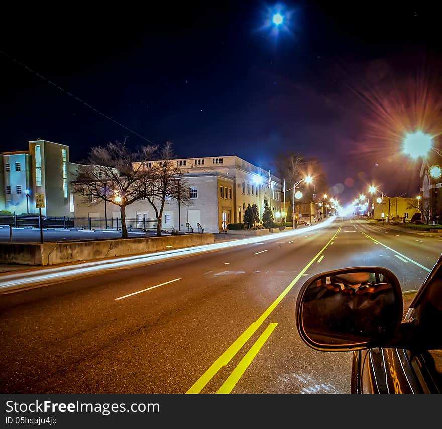 Standing in car on side of the road at night