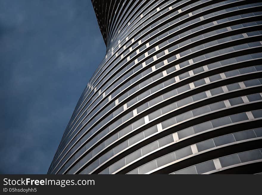 Modern styled condo building side wall on dark blue sky