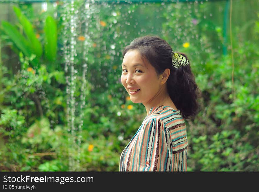 Happy young girl smiling at camera in garden