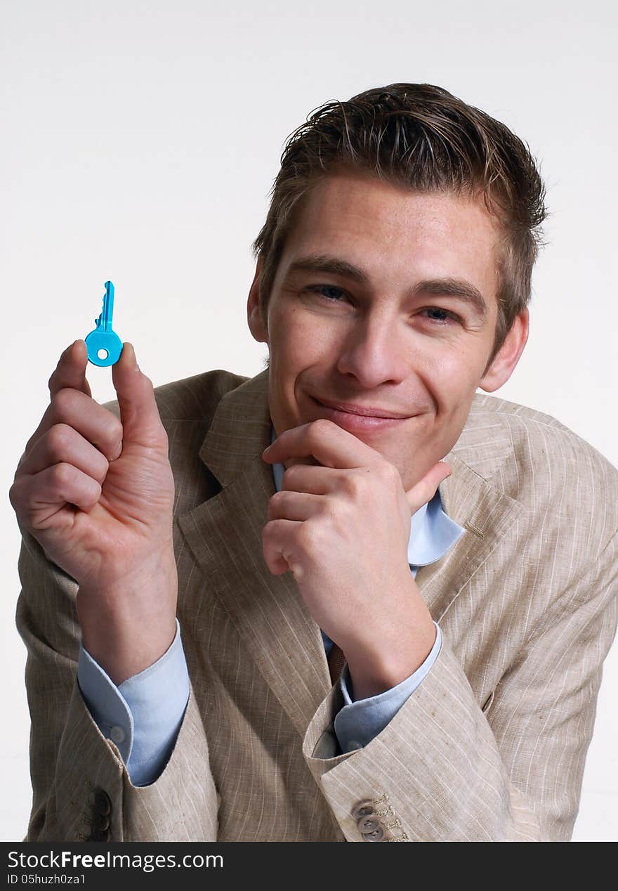 Young businessman holding a key.Salesman holding a key. Young businessman holding a key.Salesman holding a key.