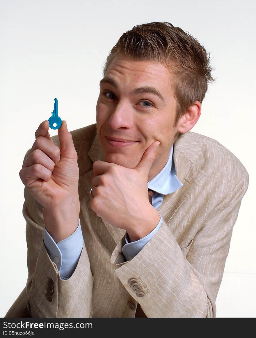 Young businessman holding a key.Salesman holding a key. Young businessman holding a key.Salesman holding a key.