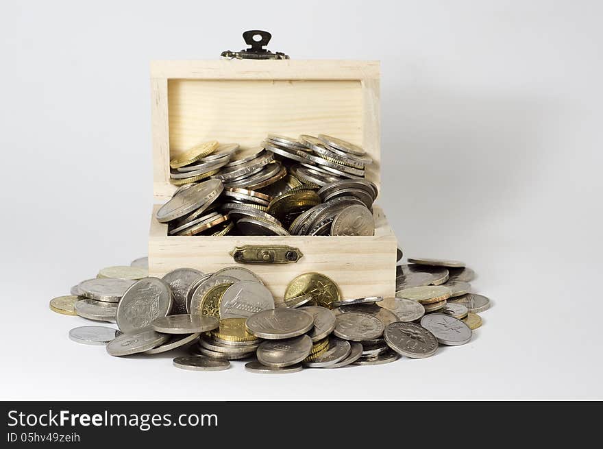 Box with coins on white background