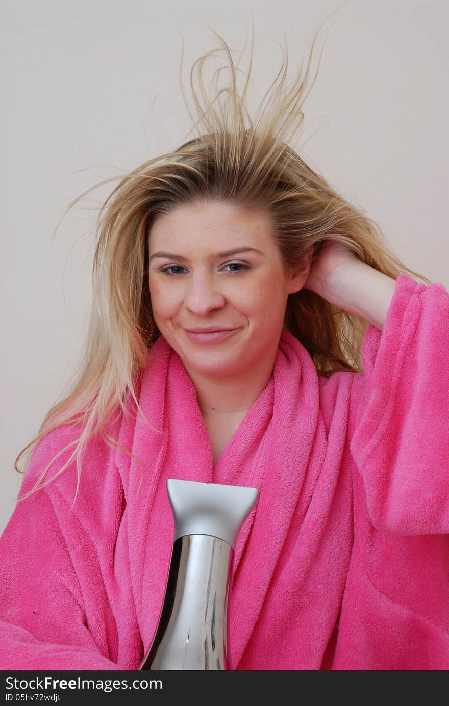 Young woman drying hair after bath. Young woman drying hair after bath.