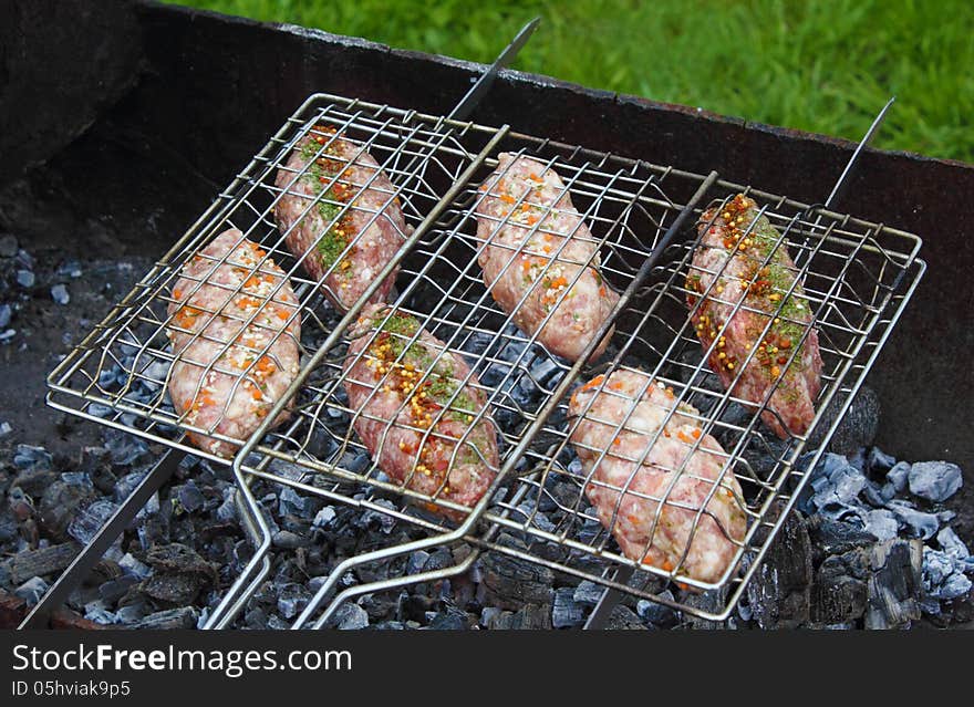 Pork and beef kebab roasting on the grill grid. Pork and beef kebab roasting on the grill grid