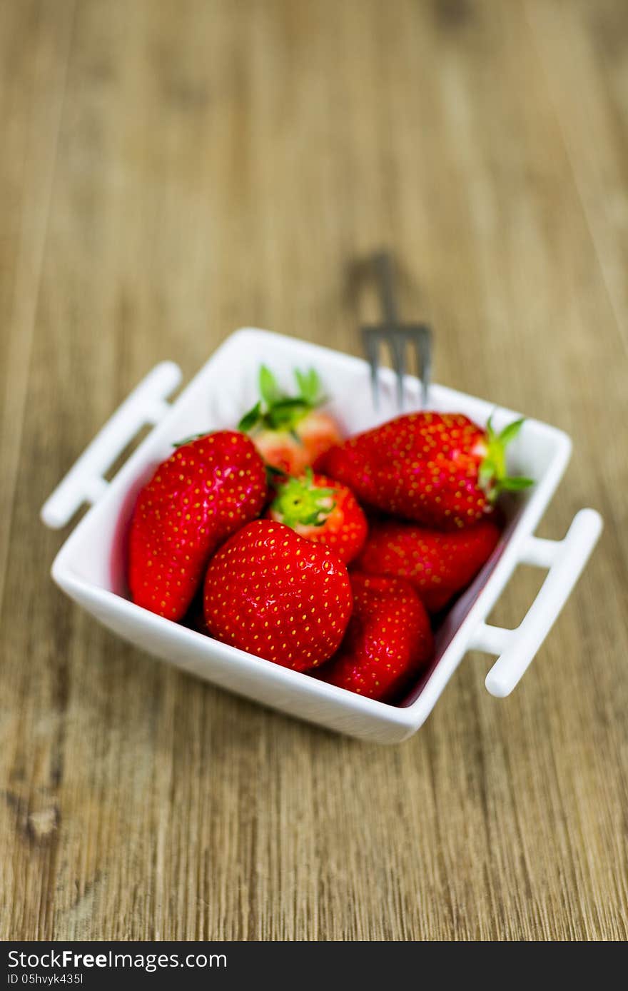 Bowl of fresh strawberries. shallow depth of field