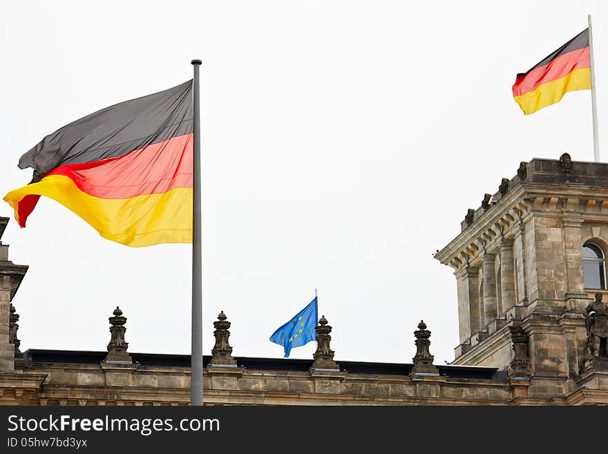 Two big German flags and one small EU flag on the roof of the Reichstag. Two big German flags and one small EU flag on the roof of the Reichstag