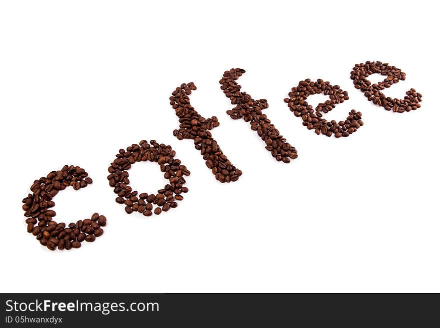 Inscription by roasted coffee beans on a white background