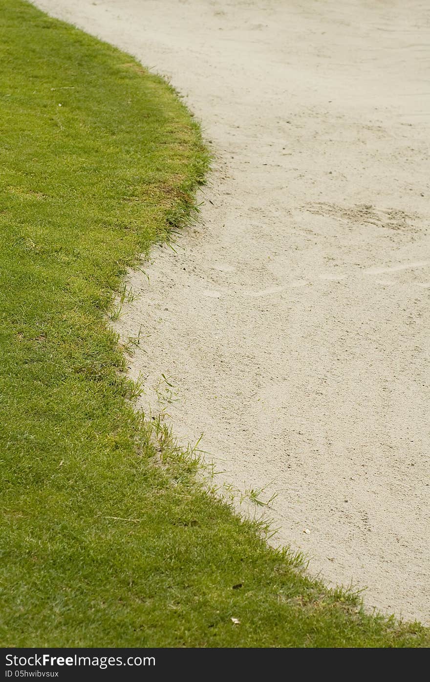 Grass and sand bunker on a golf course. Grass and sand bunker on a golf course.