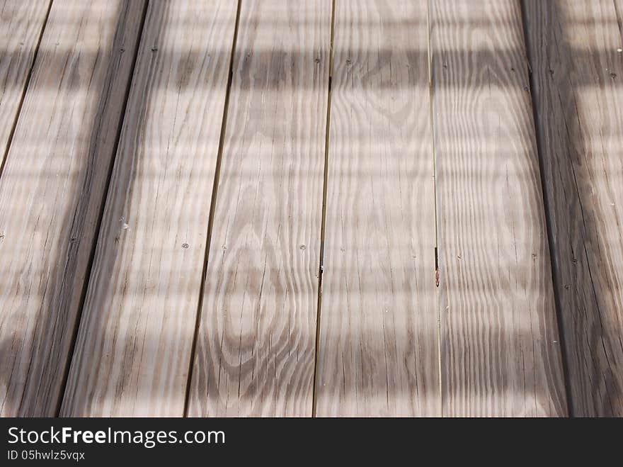 Wood decking overcast with sun shadows. Wood decking overcast with sun shadows