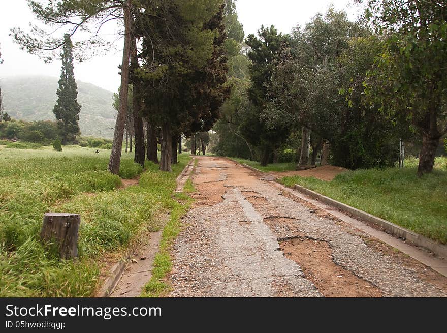 Grunge distressed road leading into misty hills. Grunge distressed road leading into misty hills