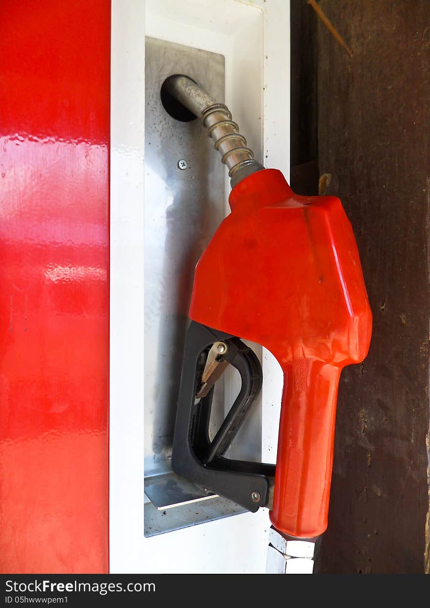 Closeup red nozzle oil station