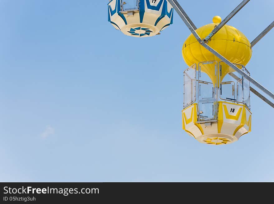 Yellow Capsule Seat Of Carousel In Amusement Park