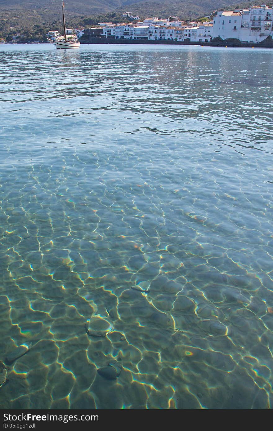 Beautiful sun dappled green-blue water of Cadaques Bay, Spain