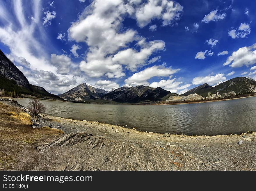 Lac des Arcs with part of the Canadian rocky mountains in the background thru a fisheye lens. Lac des Arcs with part of the Canadian rocky mountains in the background thru a fisheye lens